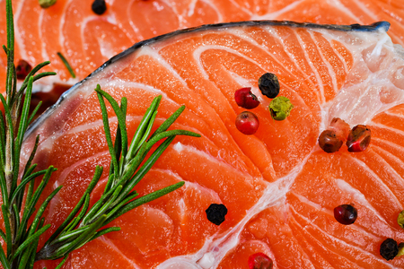 fresh salmon with rosemary, tomatoes, pepper and lemonの写真素材