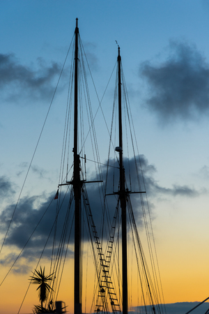 Masts of a sailboat ship in the harbor of Syracuseの写真素材