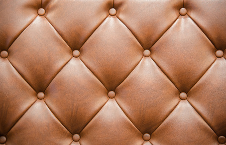 Brown Leathered Sofa with Buttons Texture Backgroundの写真素材