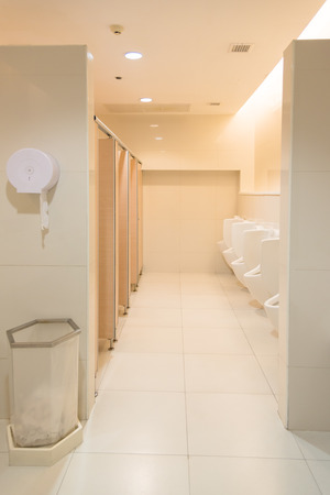Public clean modern white male toilet, restroom with urinals, interior idea concept backgroundの写真素材
