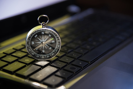 Compass shining on Keyboard metaphor to target or trend of business, marketing, finance, economy,...