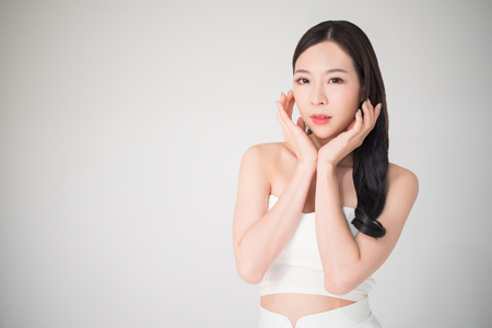 Beautiful asian woman with skin care or facial care concept isolated on white background, beauty treatment surgery concept. Facial care and skin care is the part of beauty care for asian woman.の写真素材