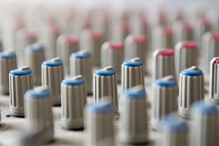 closeup of an audio mixer console in a recording studioの写真素材