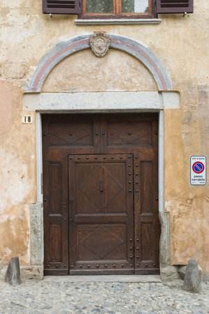ancient wood door in Saluzzo, a beautiful town in Italyの写真素材
