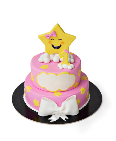 pink and yellow birthday cake isolated on white backgroundの写真素材