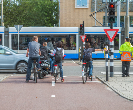 Bicycle people waiting to cross the street of amsterdamのeditorial素材