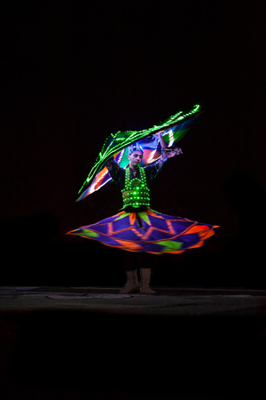 UAE / DUBAI 9/21/2012 - Local dancer with luminous suitの写真素材