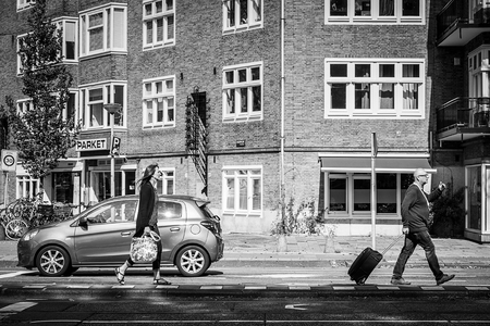 Amsterdam / Netherlands 9/12/2014 - Couple walking with bags on a street in amsterdamのeditorial素材