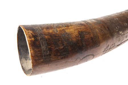 African music instrument, trumpet with African symbols, handmade, isolated on white backgroundの写真素材