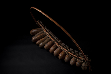 African music instrument, wooden marimba with two bakets, isolated on dark backgroundの写真素材