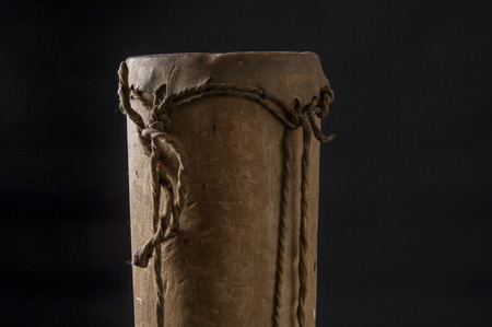 Handmade african instrument, wooden drum, isolated on black backgroundの写真素材