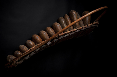 African music instrument, wooden marimba with two bakets, isolated on dark backgroundの写真素材