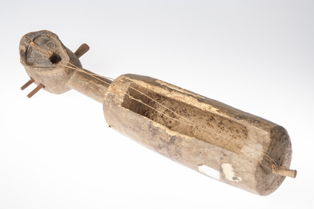 African music instrument with a face, made wooden, isolated on white backgroundの写真素材