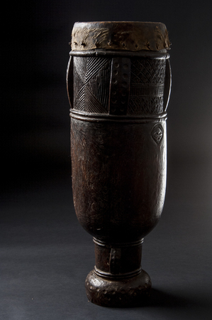 Handmade african instrument, wooden drum, isolated on black backgroundの写真素材