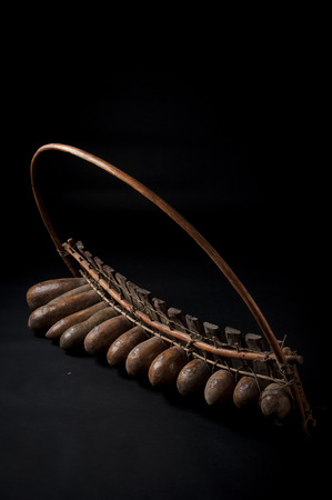 African music instrument, wooden marimba with two bakets, isolated on dark backgroundの写真素材