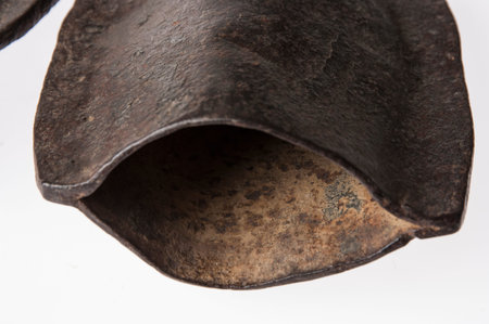 African instrument made by hand, brass, kind of bell, isolated on white backgroundの写真素材