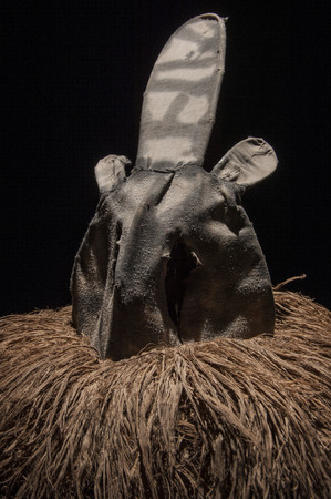 African mask with cloth hair isolated on black background, ciandaの写真素材