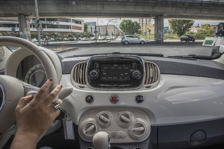 Girl driving on the promenade, view from inside carの写真素材