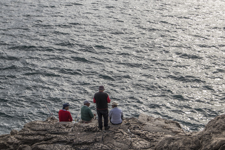 Fishermen fishing on rockのeditorial素材
