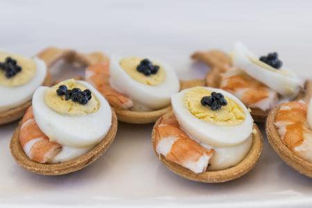 Spoons of wafer with shrimp and eggの写真素材