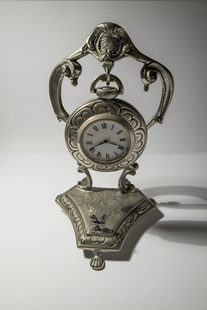 Antique silver table clock isolated on white backgroundの写真素材