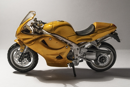 Miniature yellow sport motorbike, isolated on white backgroundの写真素材