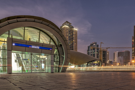 UAE/DUBAI 9 SEP 2012 - Long exposure with rails of cars light and dubai internet city metro stationのeditorial素材