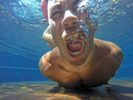 MONTARGIL/PORTUGAL-25 AUG 2016-Boy screaming under waterのeditorial素材
