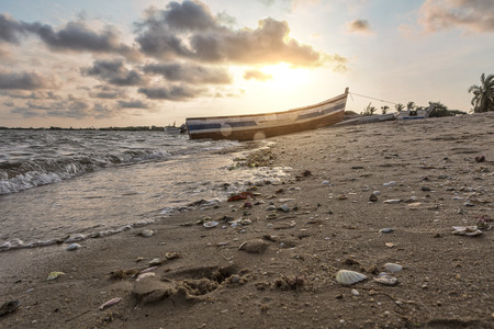 Sunset on the tropical island of mussulo angola with fishing boatsの写真素材