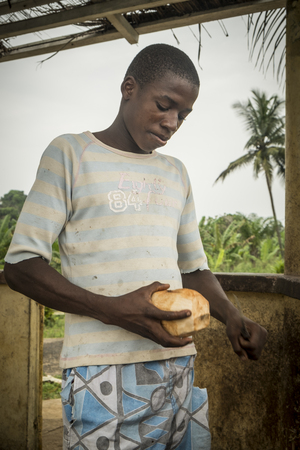 ROCA/SAO TOME - 3 JAN 2016 - Portrait of African man cutting coconut, native of Sao Tomeのeditorial素材