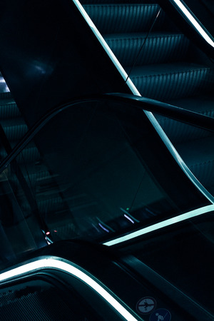 Escalators with blue lightの写真素材
