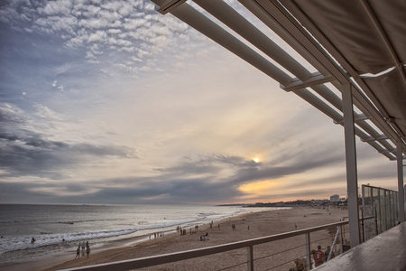 Restaurant awning overlooking the beach at sunsetの写真素材
