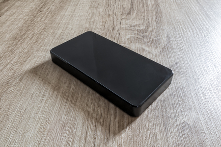 power bank phone charger isolated on wooden backgroundの写真素材