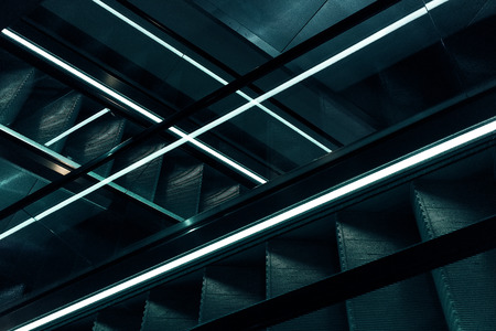 Escalators with blue lightの写真素材