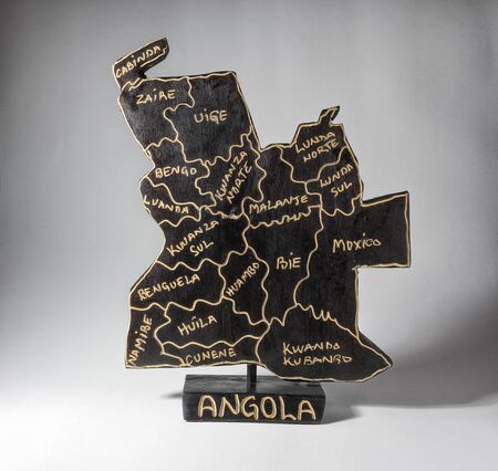 Wooden sculpture of Angola map, isolated on white backgroundの写真素材