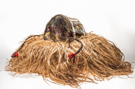 Hand made African mask with ropes simulating hair. isolated on white backgroundの写真素材