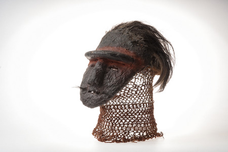 African clay mask. With human hair. Isolated on white background.の写真素材