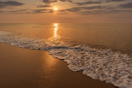Waves in the sea with sunset.の写真素材