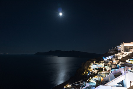landscape of oia, Santorini overlooking the caldera during night with full moon..の写真素材
