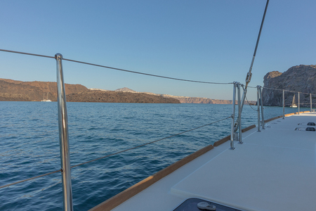 Catamaran deck overlooking santorini.の写真素材