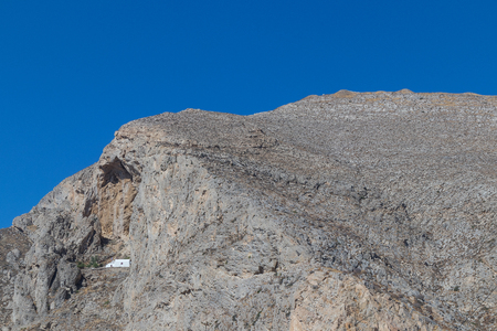 Isolated church in the middle of the mountain slope of Perissa, Santorini. Greece.の写真素材