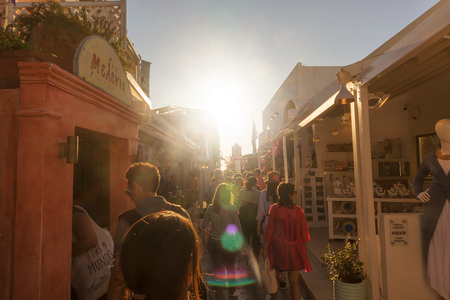 SANTORINI/GREECE 06 SEP 2017 - Tourist walking on the streets of oia, with sunset, Santorini, Greece.のeditorial素材