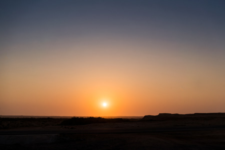 Sunset in namibe desert. With silhouette of canyons.の写真素材