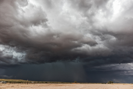 Gravel road en route to the Namibian desert with extremely dramatic sky, storm.の写真素材