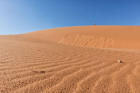 People climbing dune, Namibia. Sossusvlei.の写真素材