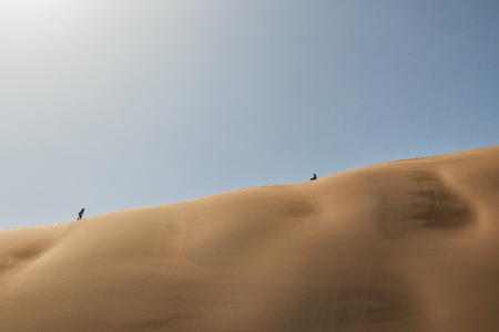 People climbing dune, Namibia. Sossusvlei.の写真素材