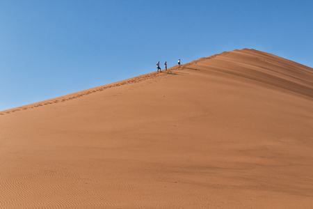 People climbing dune, Namibia. Sossusvlei.の写真素材