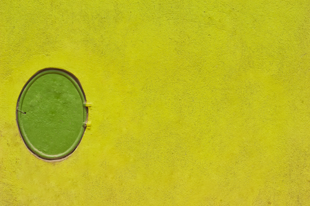 Fire hydrant on green wall.の写真素材