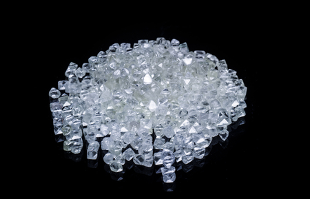 Raw diamonds isolated on black background.の写真素材