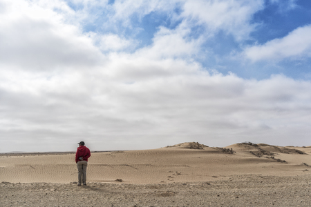 NAMIBE/ANGOLA - 26OCT2017 - Man looking at the immensity of the Namibe Desert. Africa. Angola.のeditorial素材